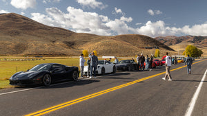 Ferrari, Porsche, Mclaren, on a supercar rally along side of the road